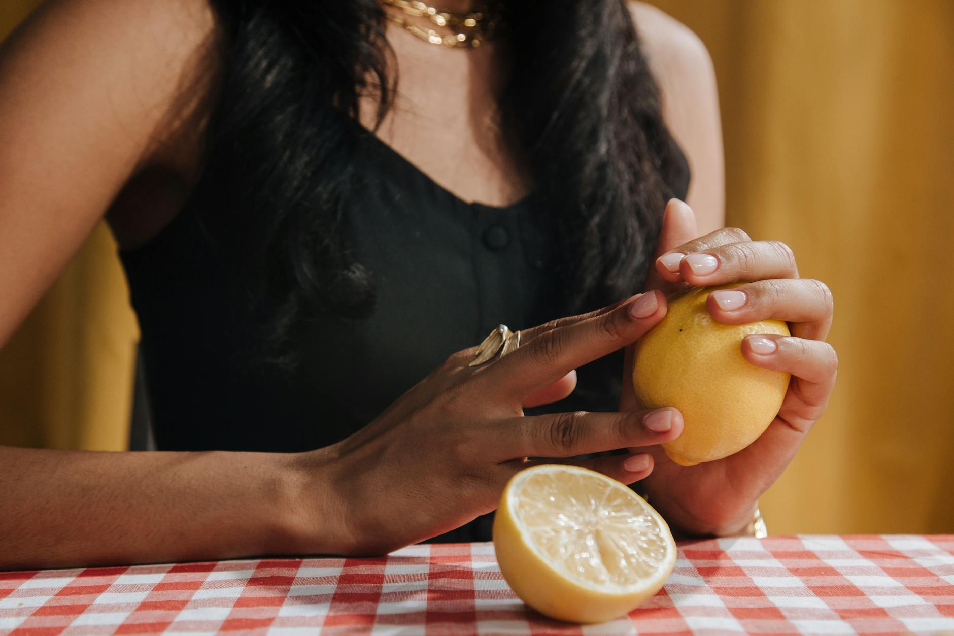 Bright yellow lemons arranged on a pastel green background, symbolizing freshness and vitality