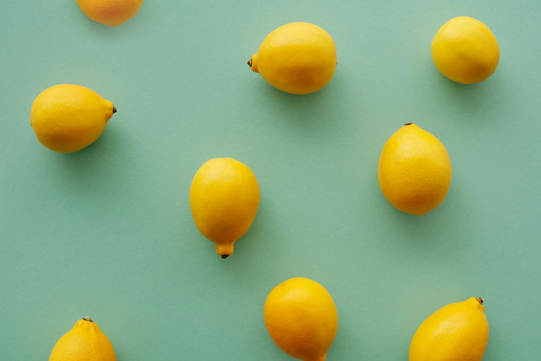 Bright yellow lemons on a pastel background representing the slow, intentional approach to pleasure