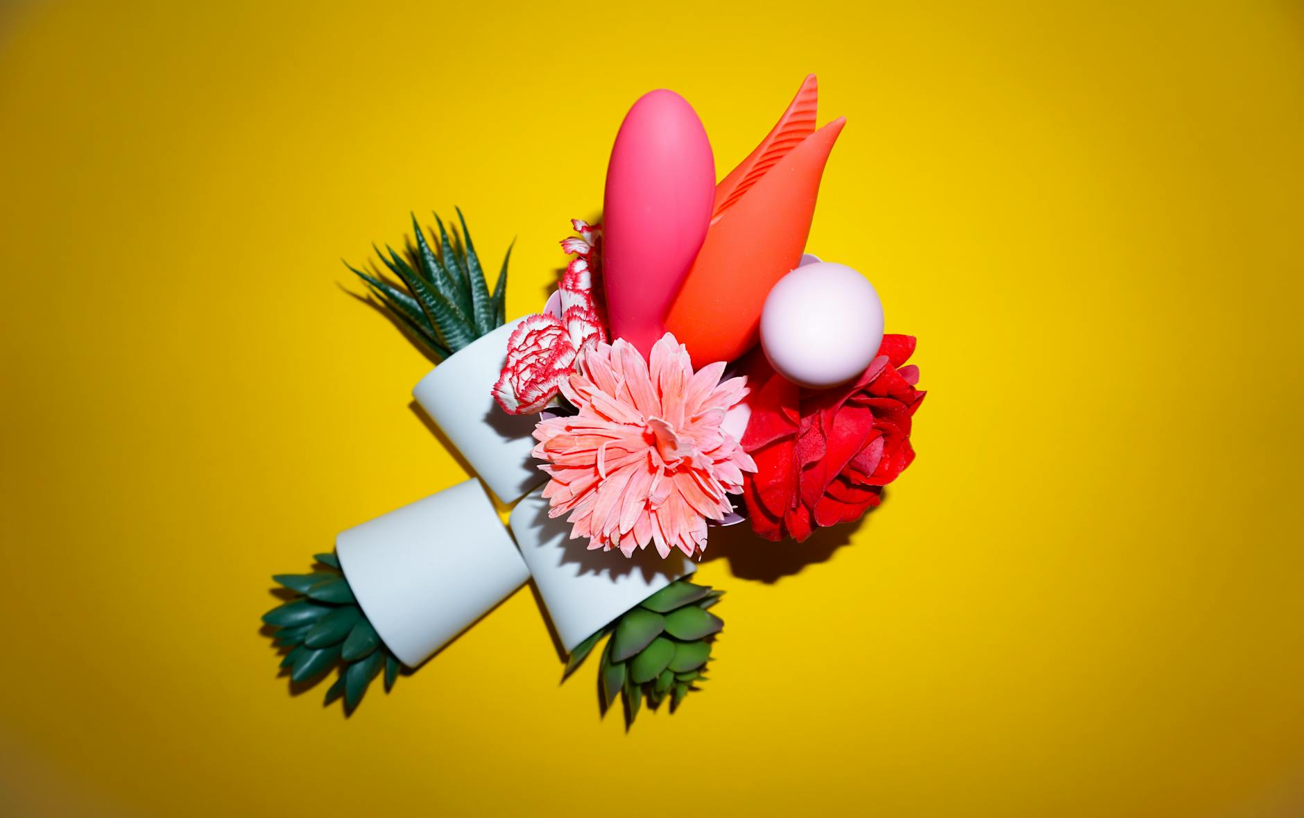 Vibrant lemon slices and colorful objects arranged on a bright yellow background, symbolizing consistent pleasure and sensory awakening.